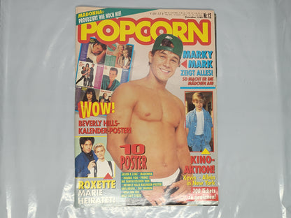Vintage magazine cover featuring a shirtless man on a white background